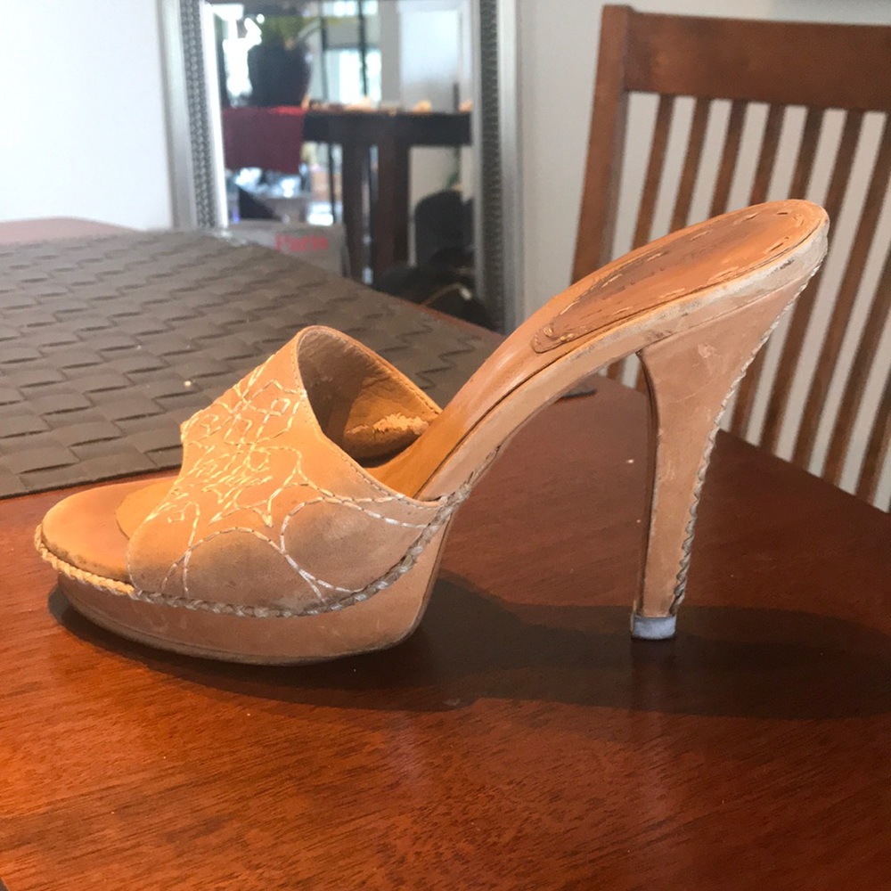 Tan leather with handmade stitch designs.